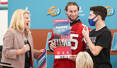 Kevin receiving Super Bowl tickets from AZ Cardinal